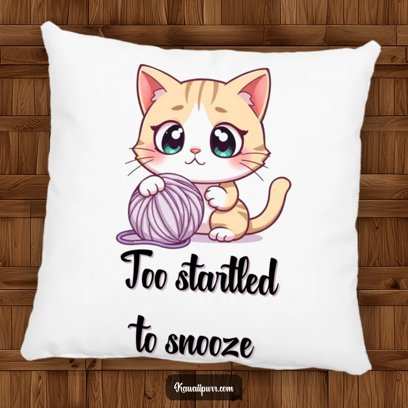 Funny pillow featuring a cartoon cat character with comically large, round eyes, looking utterly startled by a nearby yarn ball.