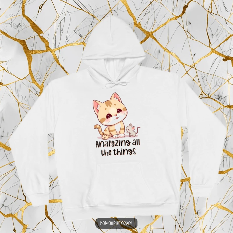 Funny curious cat hoodie showing a character tilting its head with alert ears, focused on a tiny mouse toy.