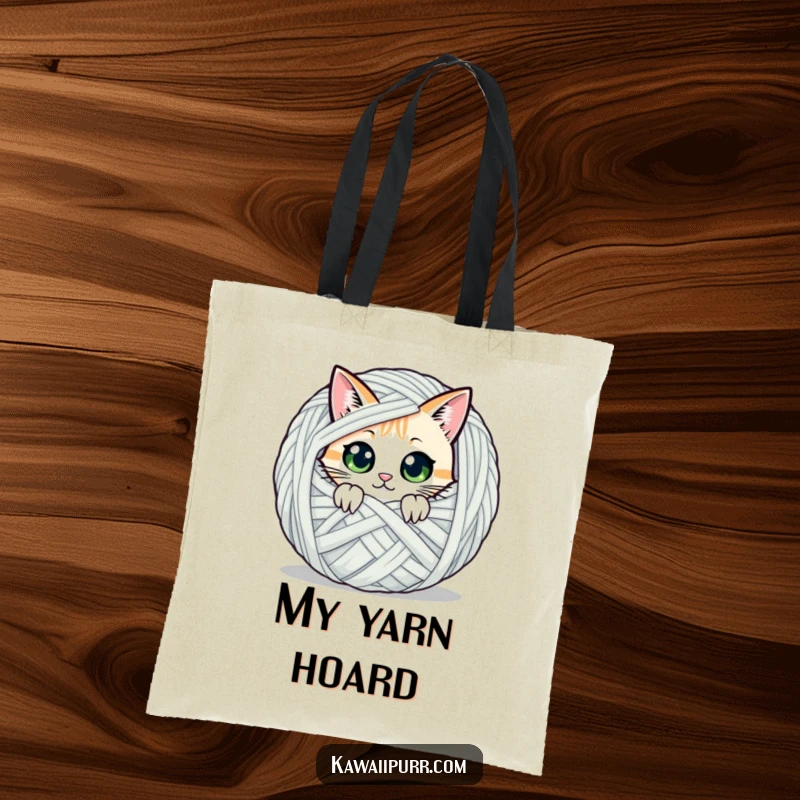 Funny tote bag showcasing a cat character peeking with wide eyes from behind a giant yarn ball, perfect for carrying essentials.